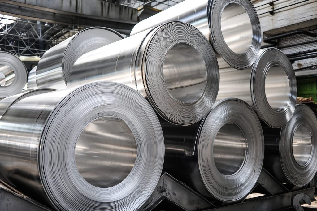 Rolls of aluminium sheets stacked on each other.